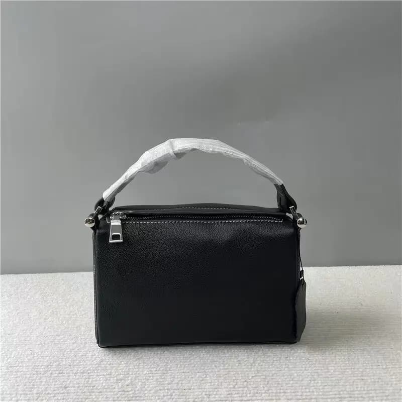 Mini square leather handbag, short and portable with a top handle, silver metal zipper, and spherical hardware.