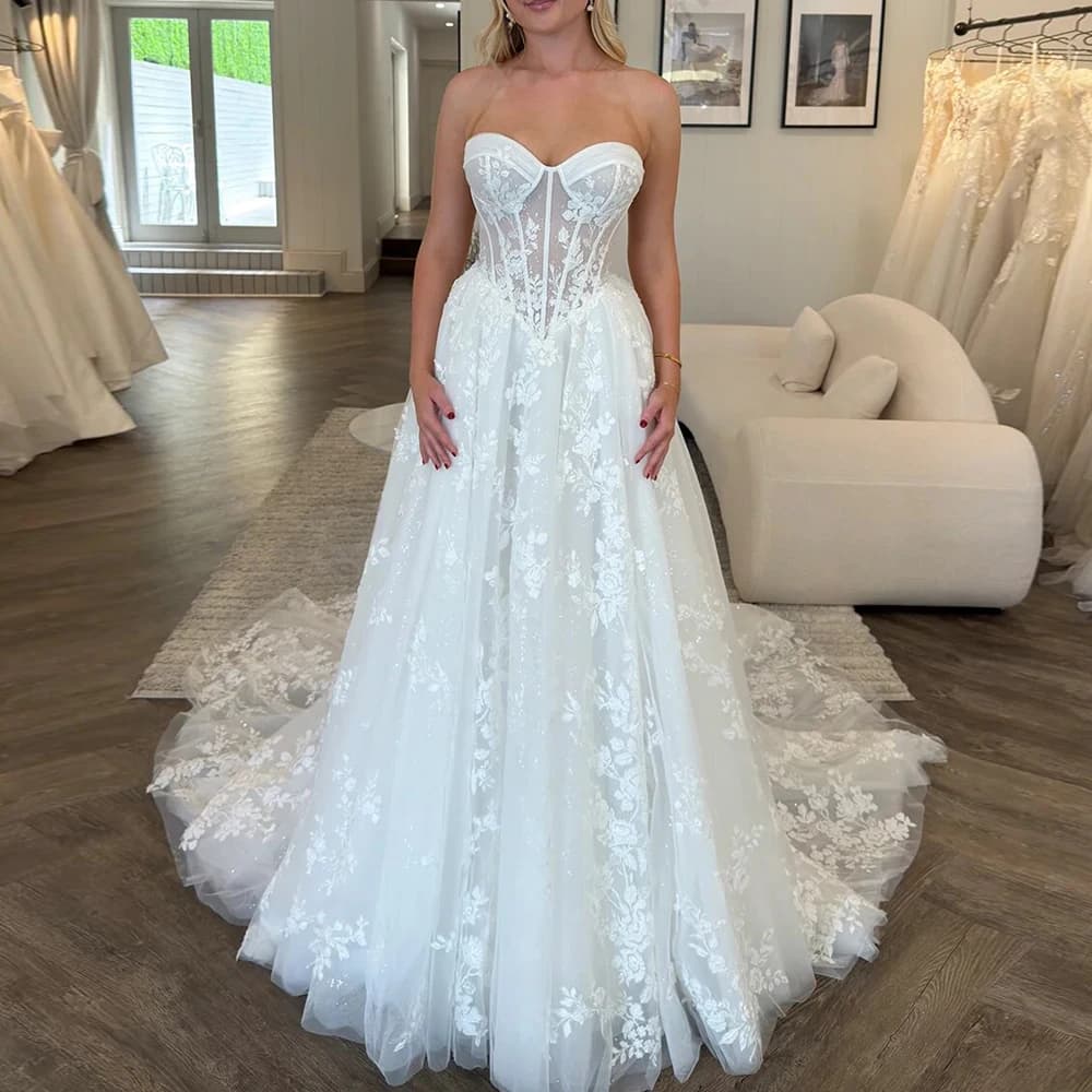 Abiti da sposa personalizzati con applicazioni in tulle glitterato a trapezio Abiti da sposa senza maniche con scollo a cuore Abiti da sposa con corsetto Boho