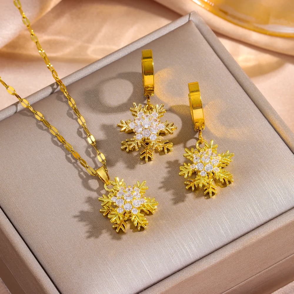 Nuovo set di gioielli da donna in acciaio inossidabile placcato oro 18 carati con collana e orecchini a forma di fiocco di neve girevole.