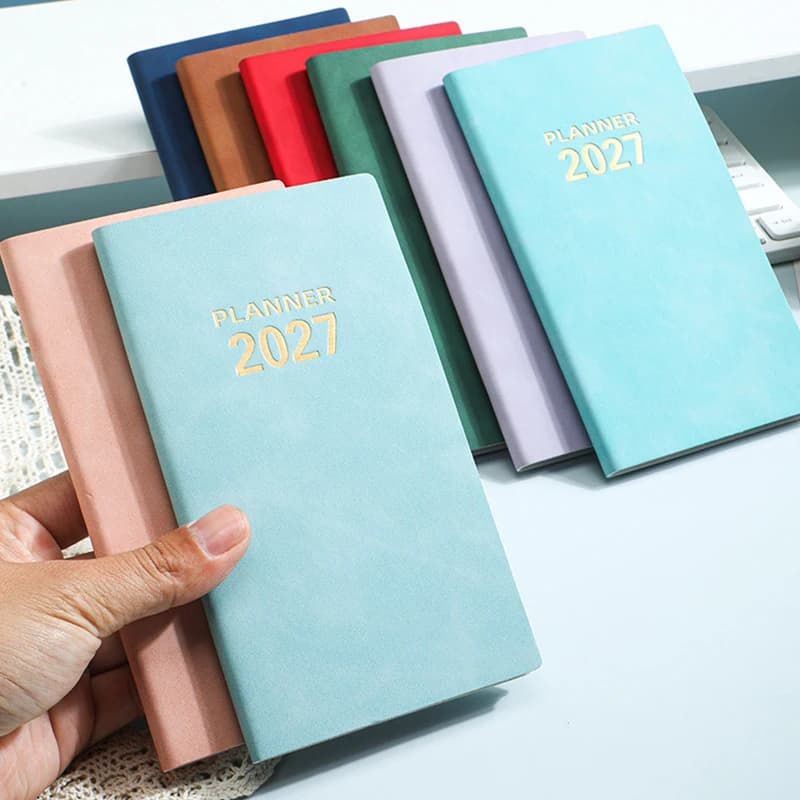 2027 Weekly Monthly Planner Notebook A6 Portable Schedule Book with Ribbon Bookmark Calorie Counter World Holidays Info Journal