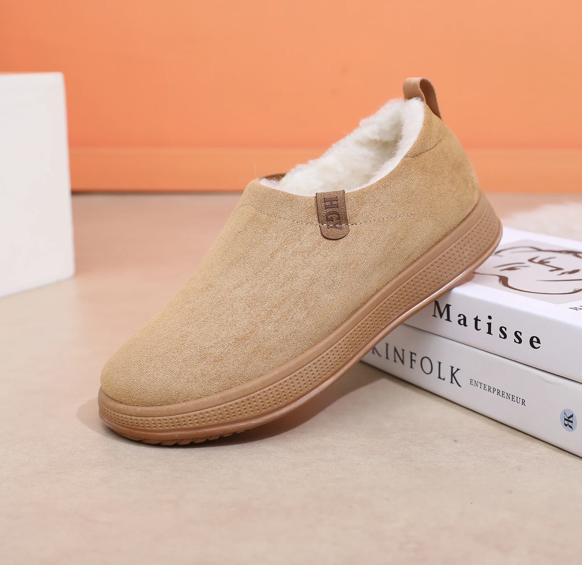 A pair of minimalist men's snow boots, elegant and fashionable, lined with delicate plush on the skin that freezes to heat