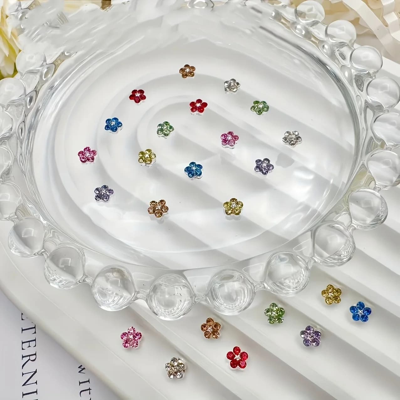 A Set of 24 Assorted Nail Embellishments Featuring Mini Five-Petal Diamond Flowers with a Metallic Base, Offering a Three-Dimens