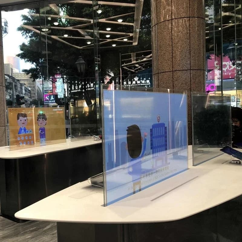 Intelligent interactive transparent OLED touch monitor support that advertises digital signage display