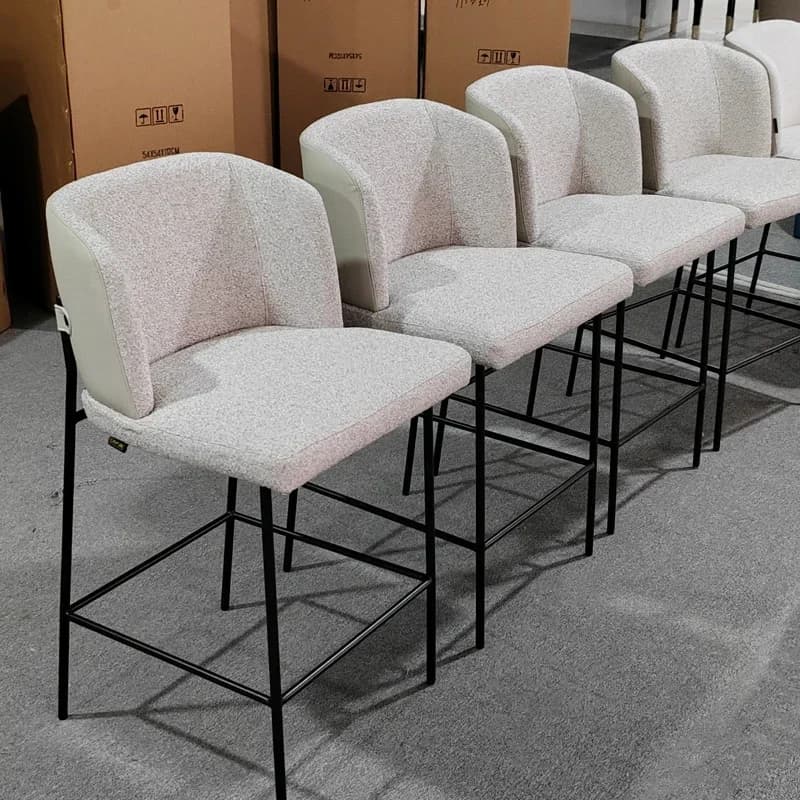 A modern and luxury dining chair with leather backrest and linen cushion. Hotel restaurant bar chairs