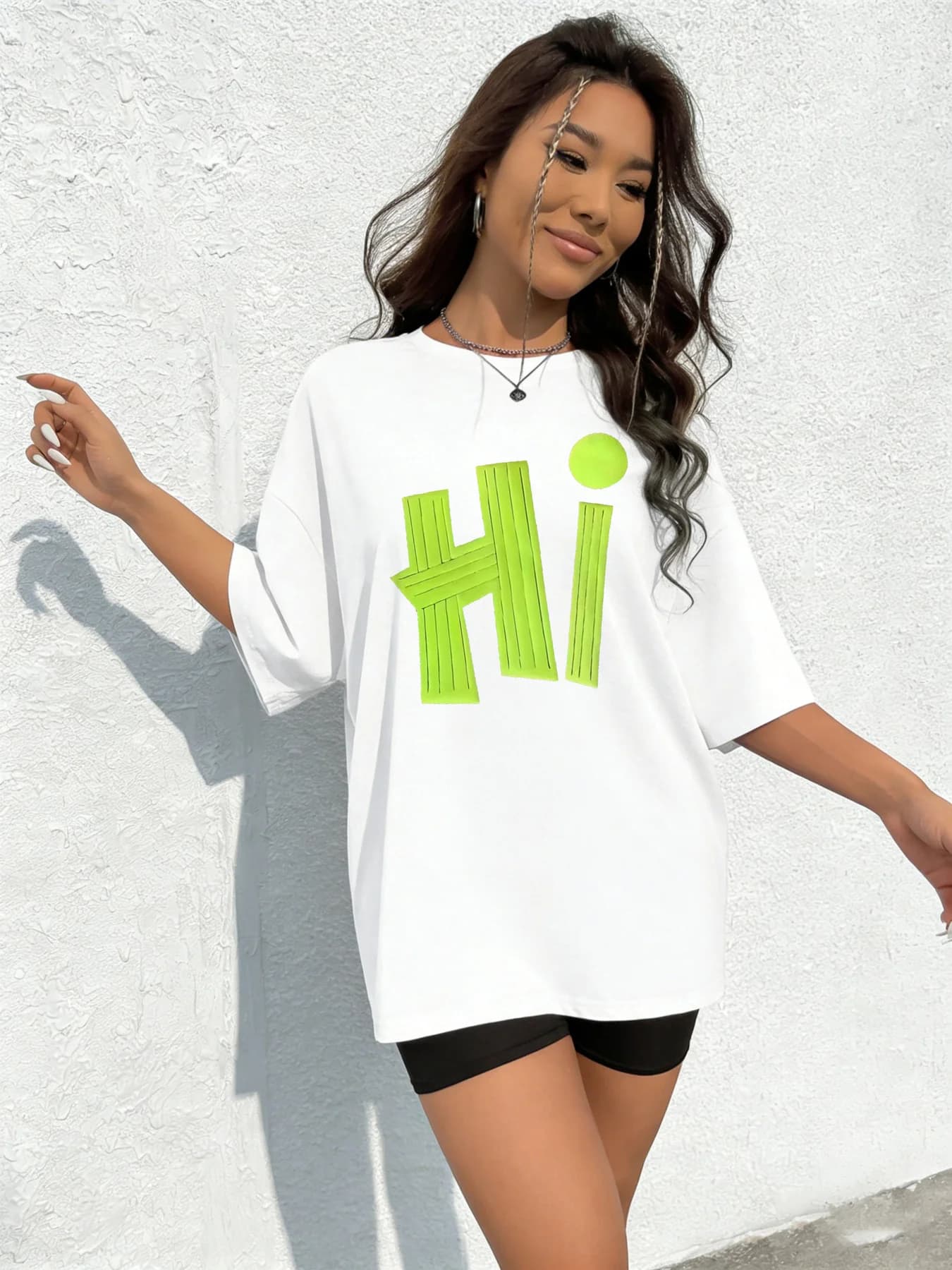 Two-piece set consisting of an oversize shirt with green fluorescent print and cycling shorts