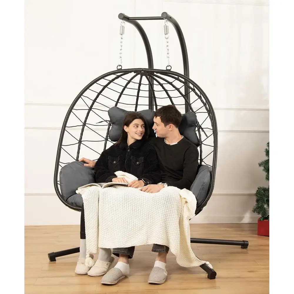 Double egg-shaped rocking chair with support, UV-resistant cushions, capacity of 700 pounds, ideal for indoor or outdoor use