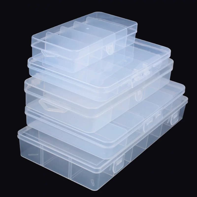 Transparent box for baits with five or six compartments to store artificial baits. PP plastic fishing gear box. Multifunctional accessory.