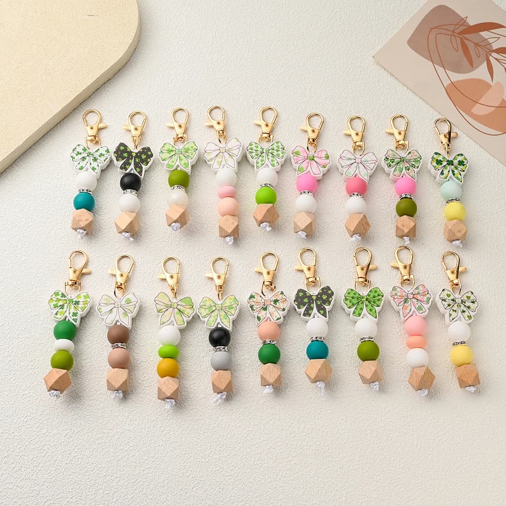 1 Pezzo Ciondolo in Silicone a Forma di Fiocco con Perline, Gancio per Passeggino, Charm per Borsa, Portachiavi, Accessori Decorativi in Silicone