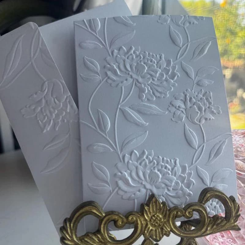 A set of elegant flower design 3D embossed folders with plastic white fantasy theme templates for scrapbooking, card making, and