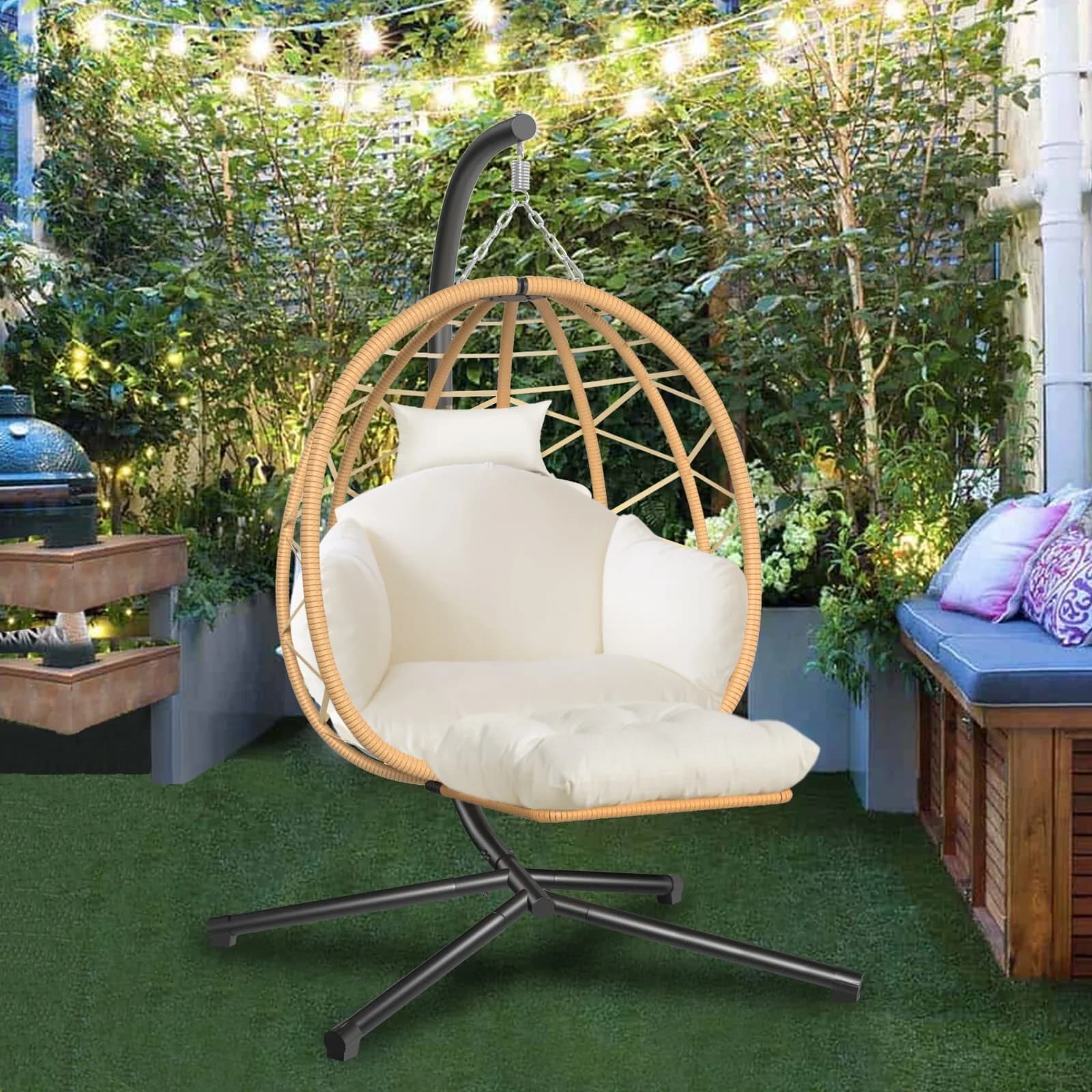 Outdoor hanging rocking chair in wicker with UV-resistant support and cushions