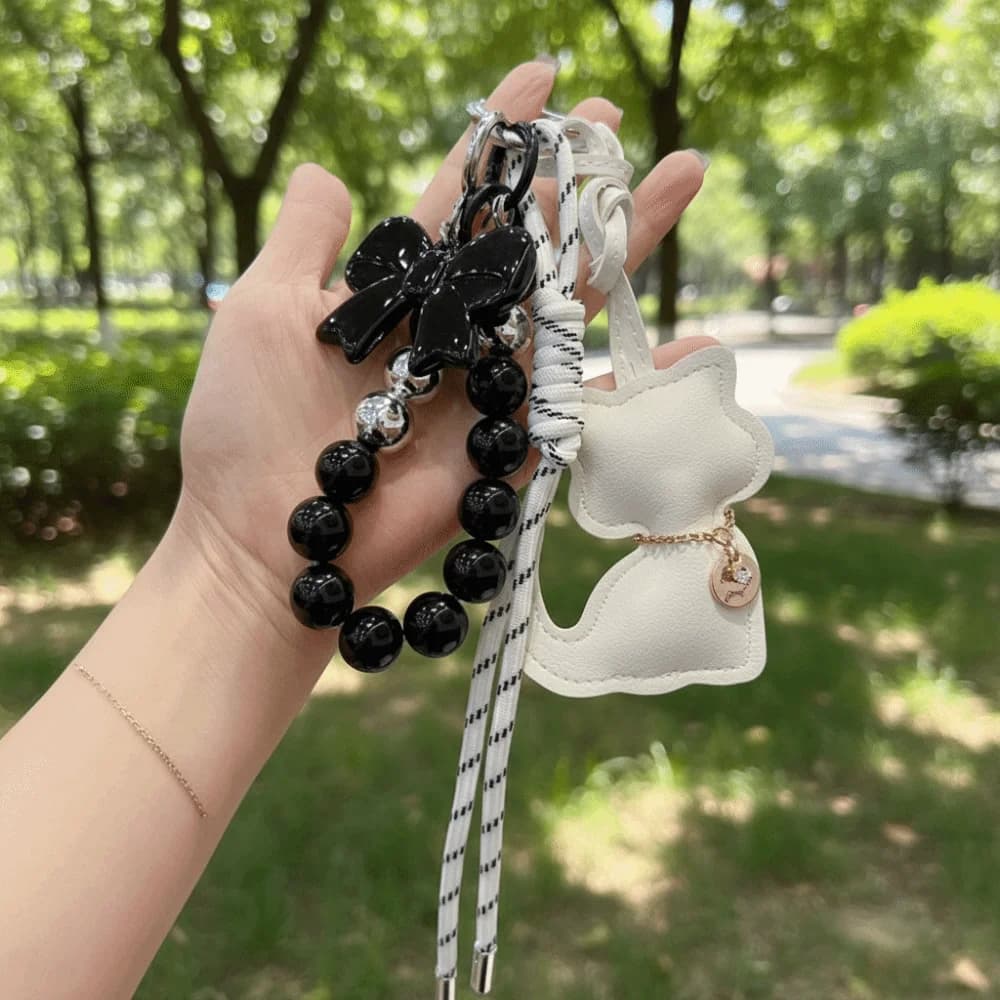 Portachiavi con Ciondolo Gatto in Pelle e Perle, Fiocco Carino, Stile Lusso Leggero, Ciondolo Creativo per Borsa, Regalo