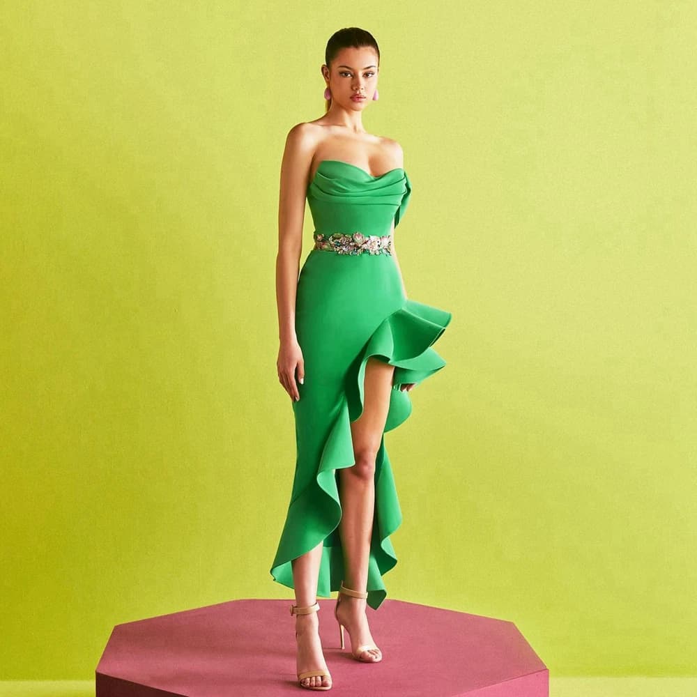 Elegant satin evening dress without shoulder straps with asymmetrical high slit volant. Party life dress in pretty floral lace. Summer formal dress