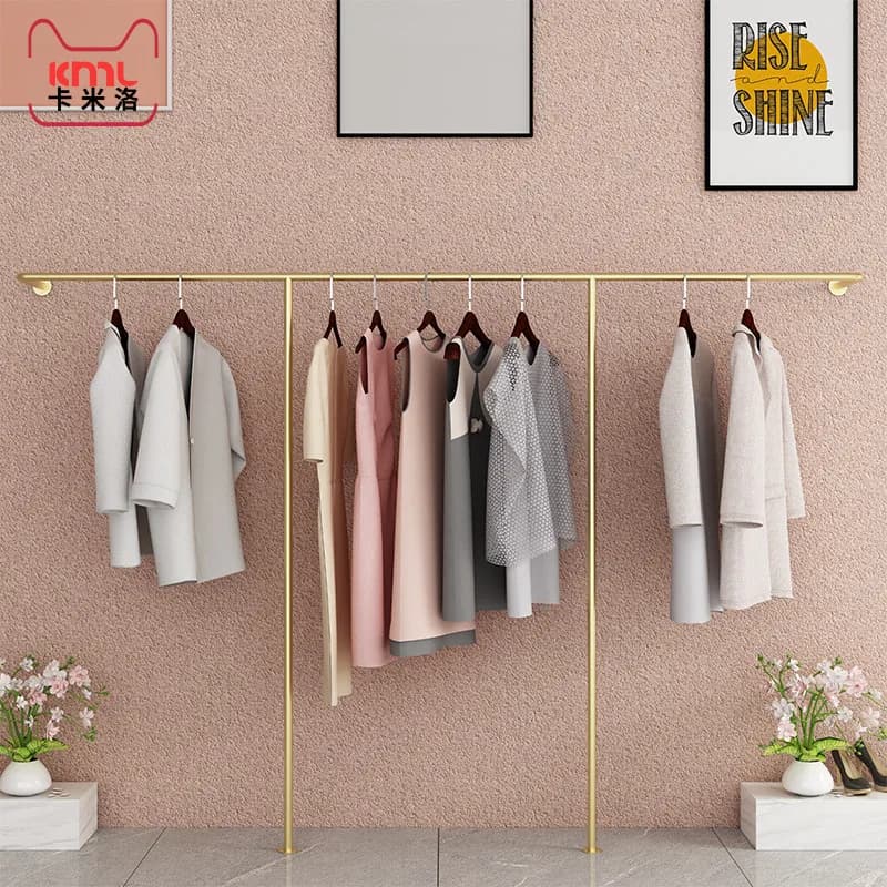 Espositori in ferro battuto per negozi di abbigliamento, espositori dorati, decorazioni murali, appendiabiti da parete, abbigliamento femminile, abiti da vetrina