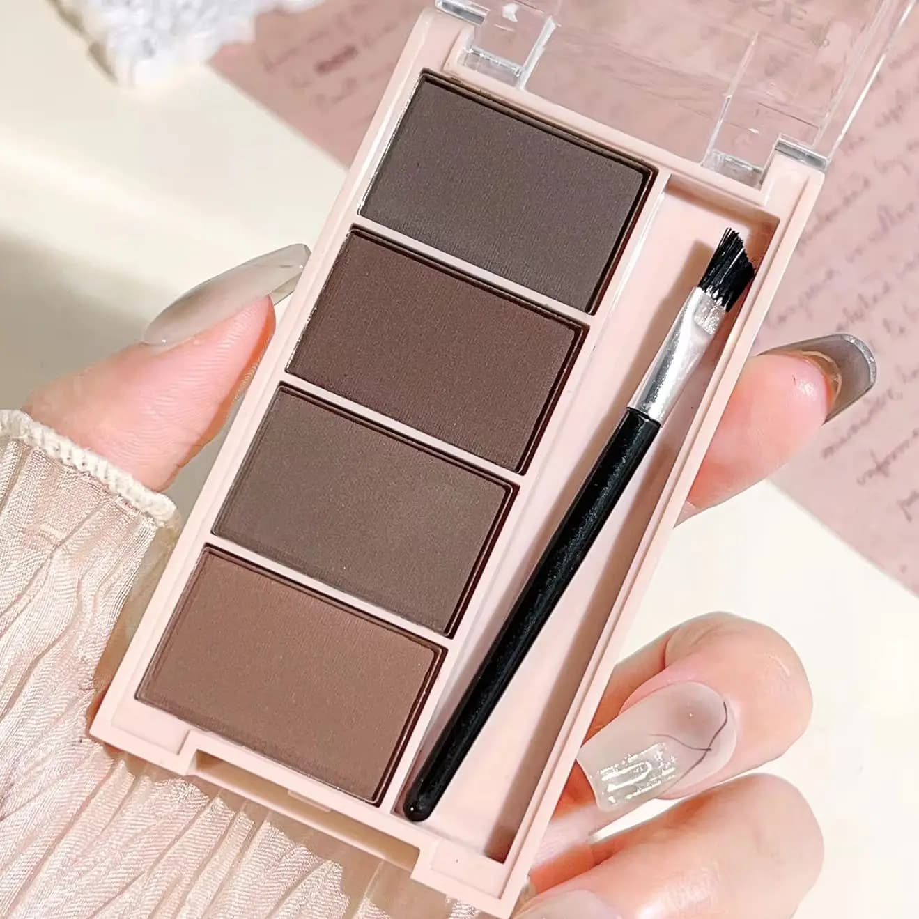 A set of 4-color eyebrow powder trays with gray tones and matte brown brushes for rendering, filling and long-lasting s