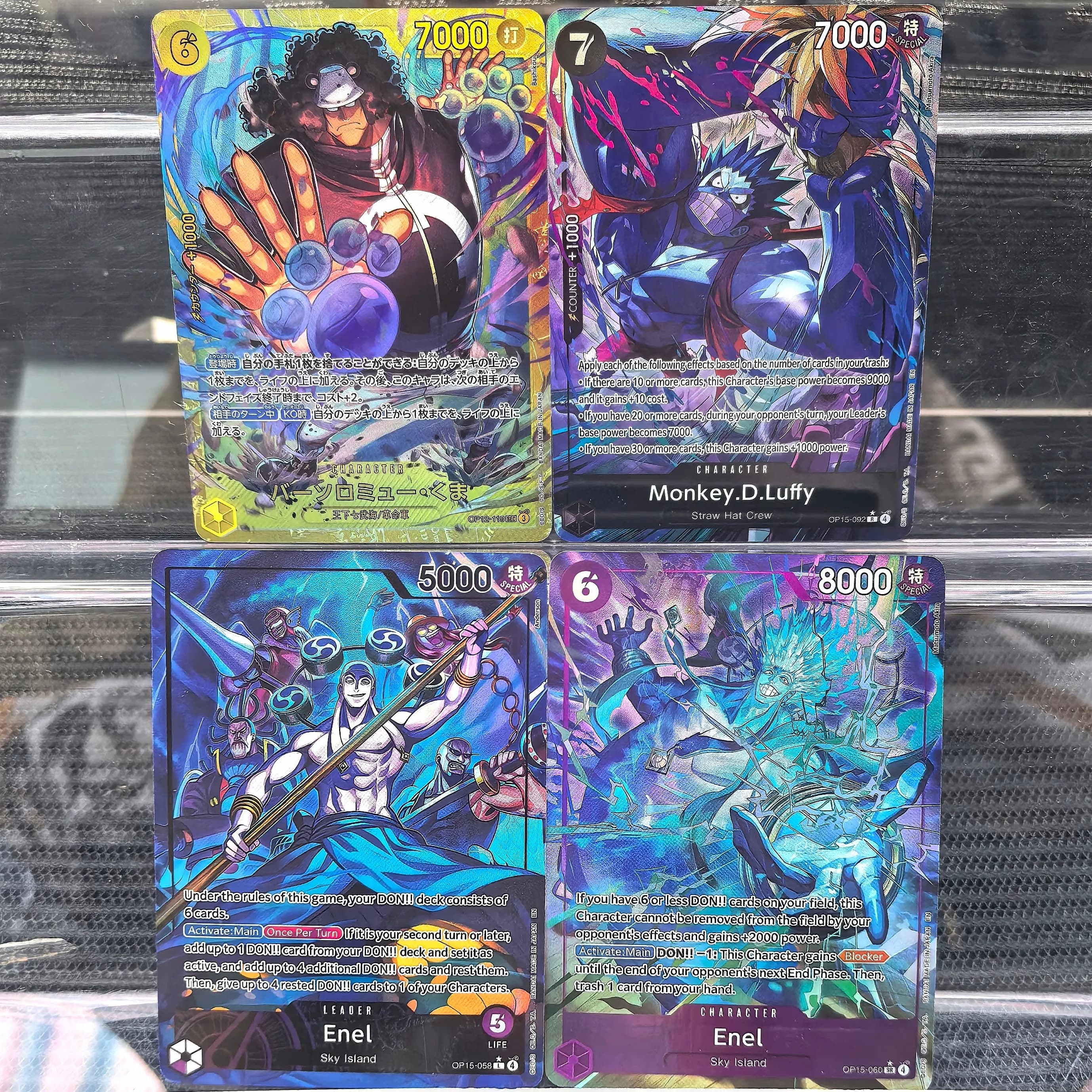Collezione One Piece Card Game OP-15: Carte LEADER Rare di Enel (Sky Island) + Carte ad Alto Poder di Luffy e Bartholomew Kuma per Esposizione