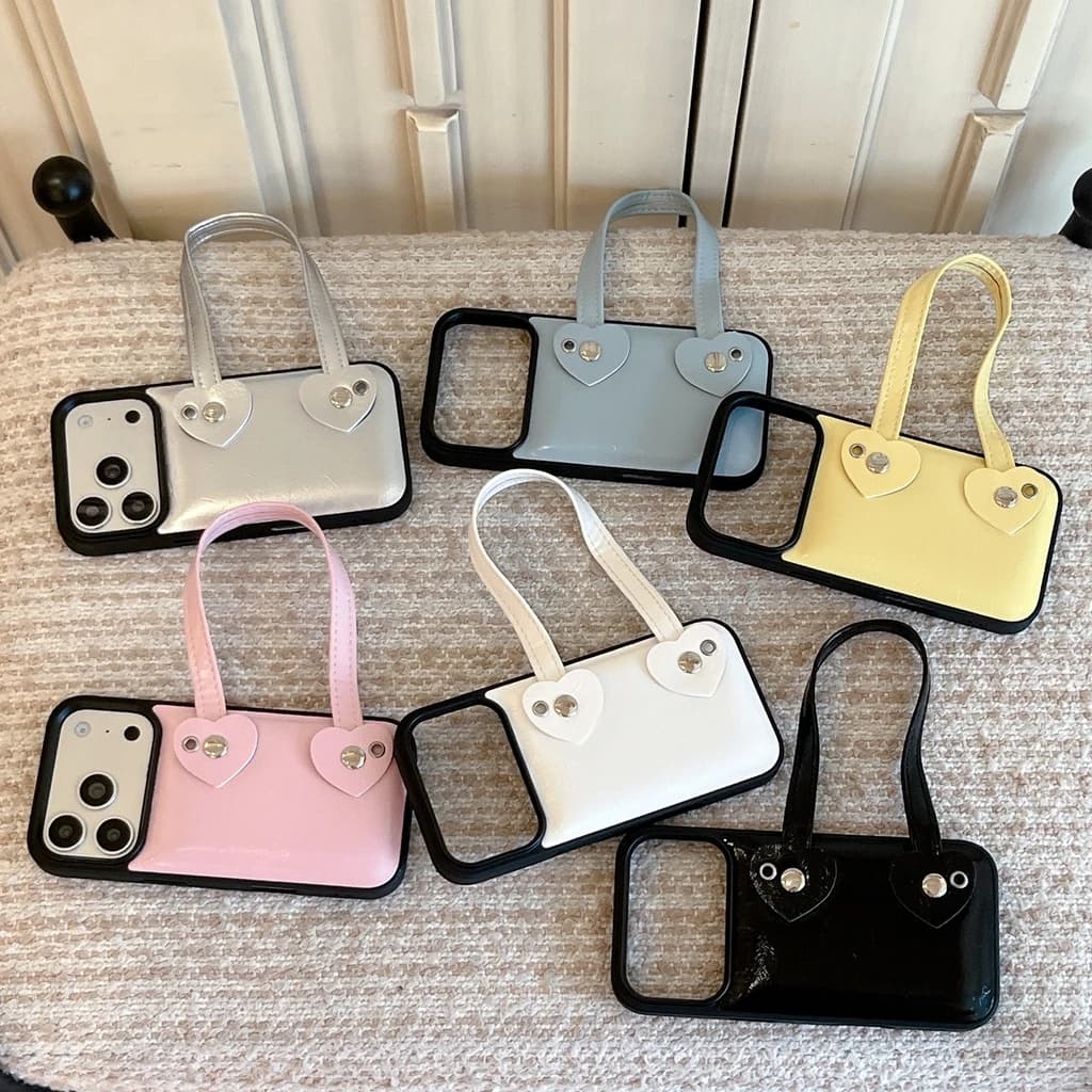 Custodia Protettiva Antiurto in Ecopelle con Cinturino da Polso a Cuore Creativo e Rivetti alla Moda per iPhone 17 16 15 Pro Max