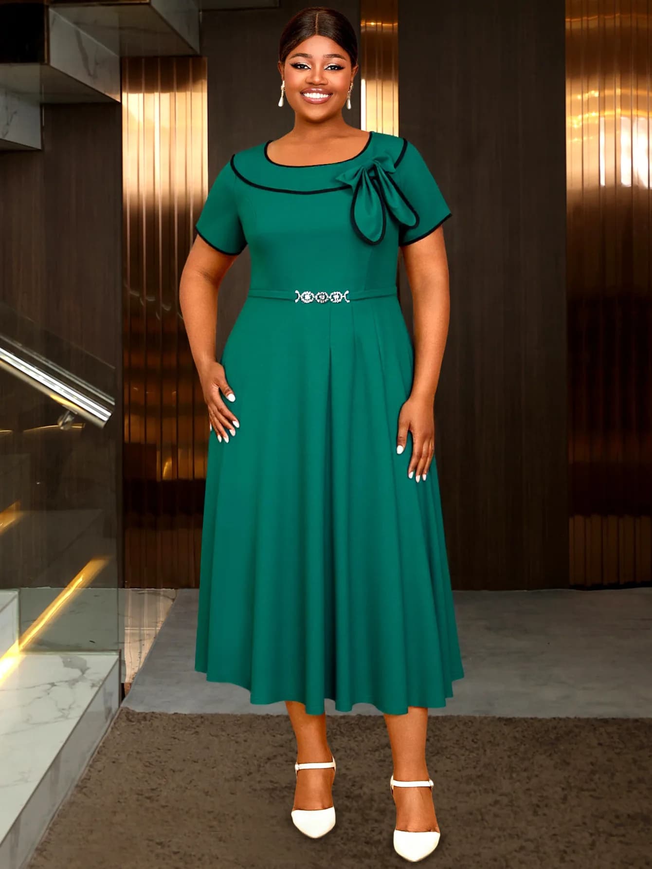 The new short-sleeved dress with big bow on the neck and contrasting edge, decorated with belt, in green lake.