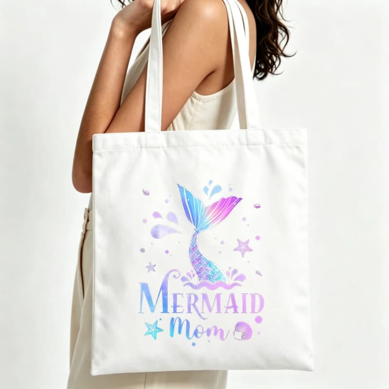 Women's mermaid tail graphic canvas tote bag with letter print, perfect for summer beach outings and casual daily use