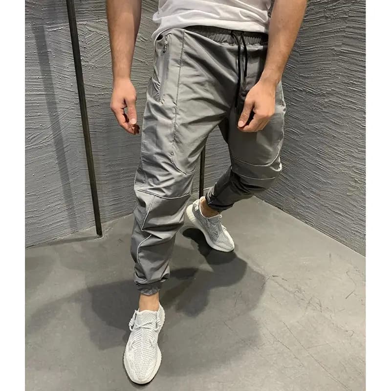 Pantaloni sportivi muscolari Pantaloni casual larghi da uomo primaverili e autunnali ad asciugatura rapida Cinghie luminose Pantaloni fitness da corsa Alla moda