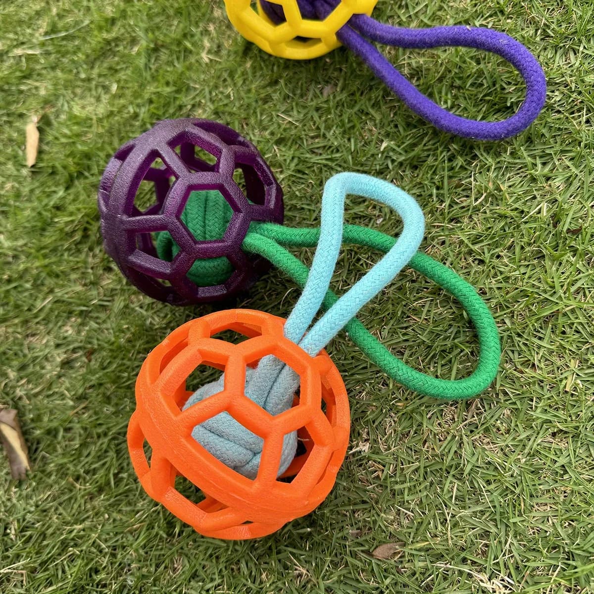 Durable Hollow TPR Dog Chew Ball With Braided Rope Handle Teeth Clean Interactive Training Toy For All Canines