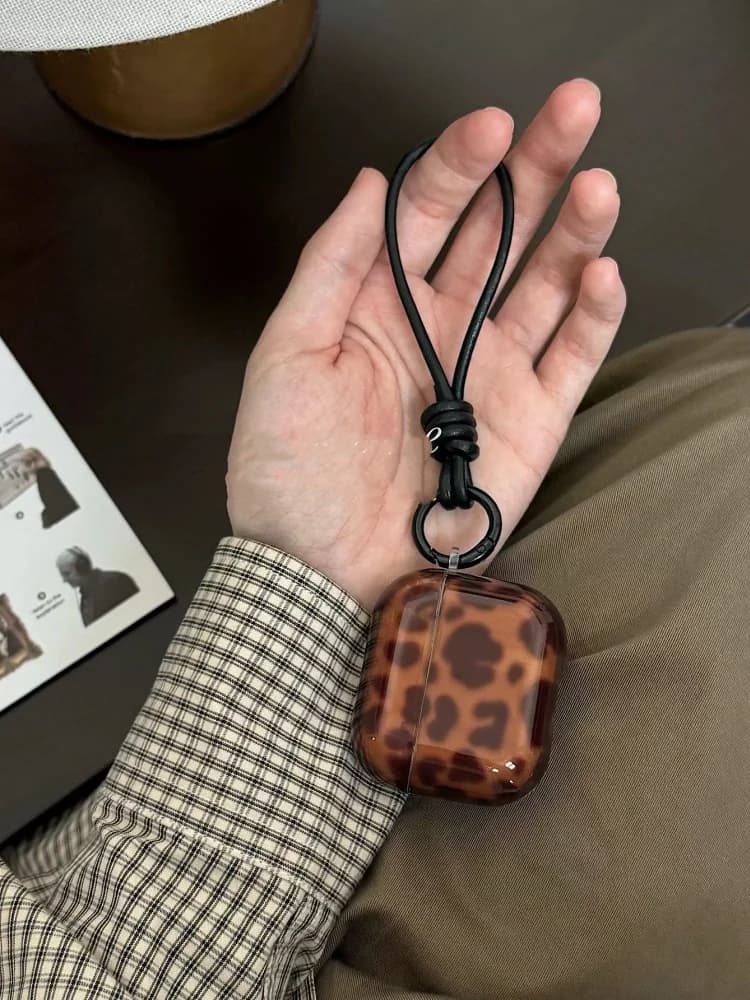 Airpods 4 generation headphone case with amber leopard print with niche leather strap suitable for Iphone 3 Pro protection