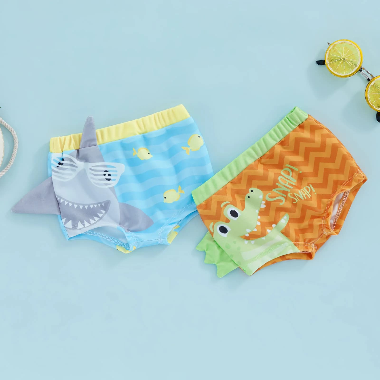 Pantaloncini da bagno casual per neonati e bambini, bauli elastici, fascia con stampa squalo, costume da bagno estivo elasticizzato ad asciugatura rapida con design a cartoni animati