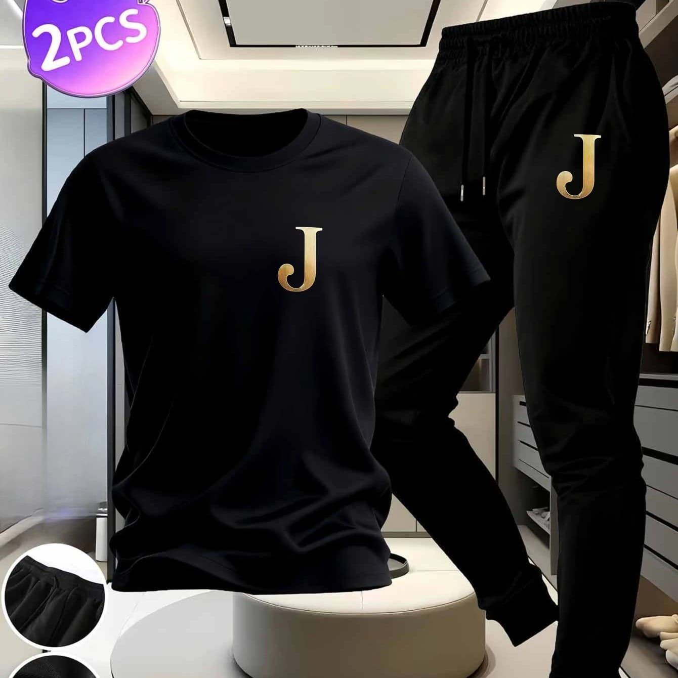 Short-sleeved cotton t-shirt with "J" print and black sports trousers with golden "J" pattern.