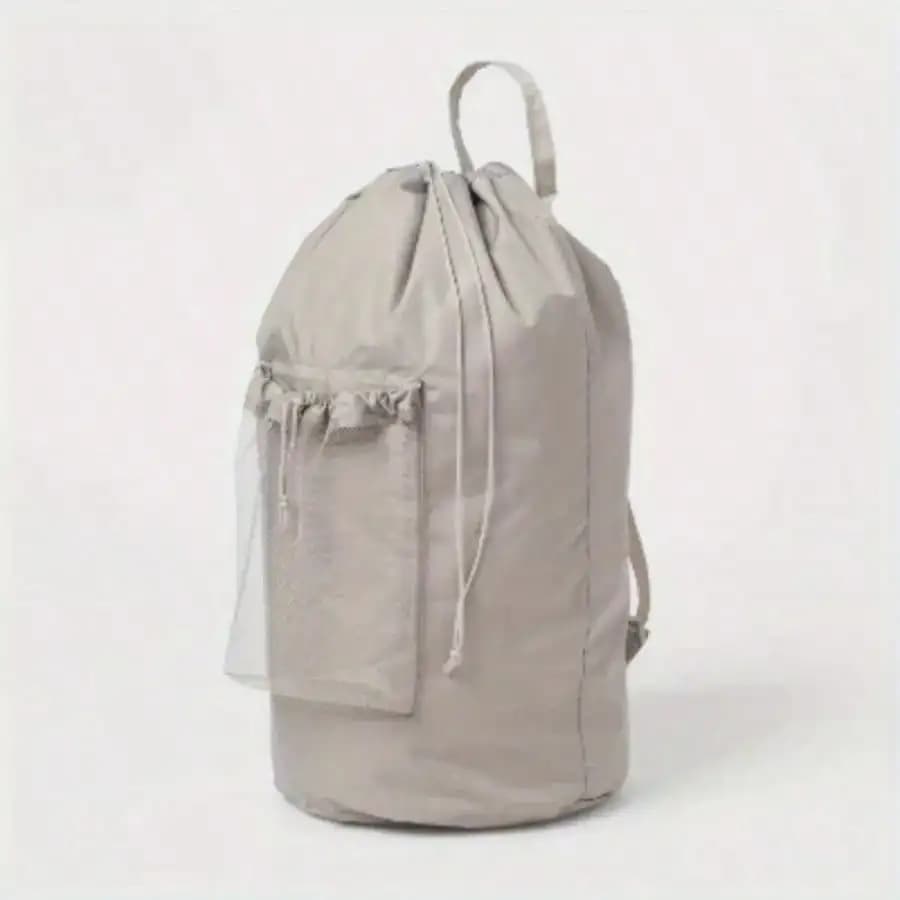 Backpack bag in grey textured with side pockets on the net to help you small separate colorful items