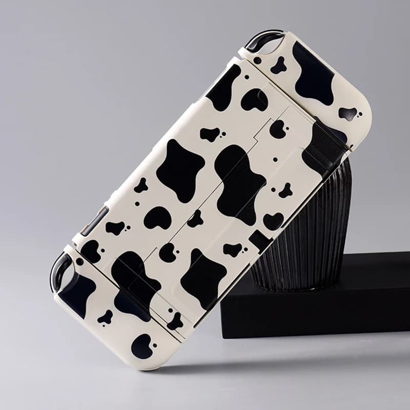 Custodia protettiva rigida in venature di mucca e cover morbida JoyCon per Nintendo Switch/OLED con 1 paio di impugnature per pollice per Nintendo Switch Shell