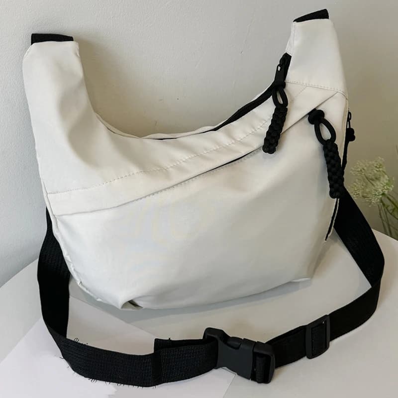 Neutral style tote bag with strap for carrying fitness items. New mini street-style handbag with shoulder strap. Lightweight and
