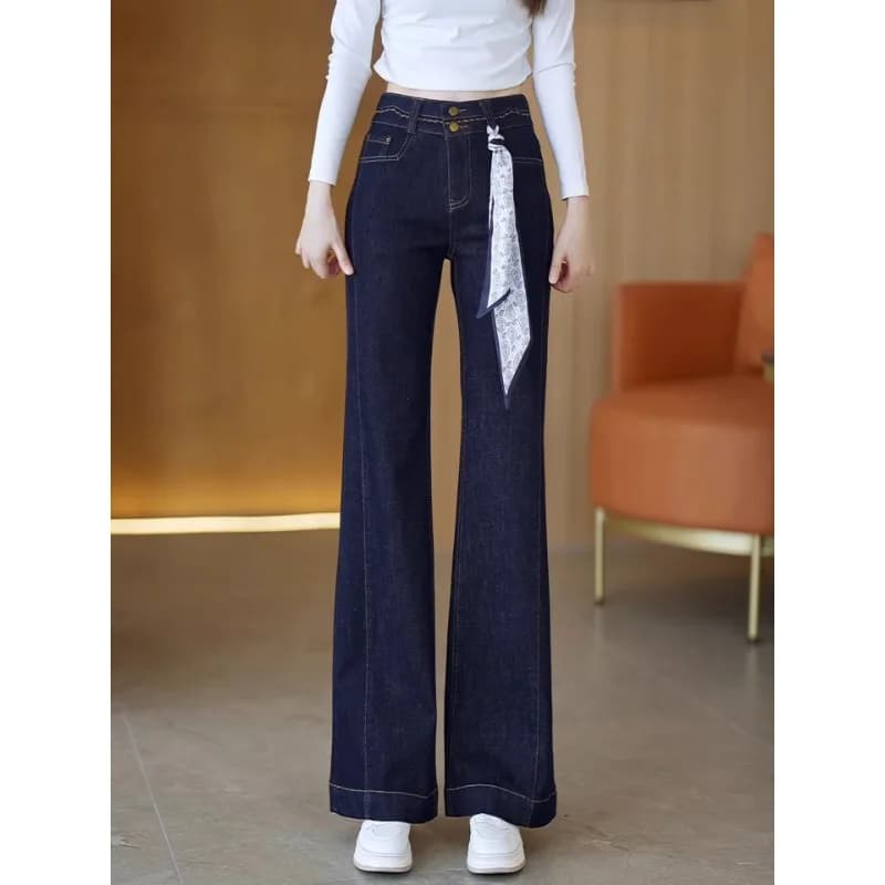 Women's and winter denim blue jeans, elegant trousers draped by casual leg up to the floor