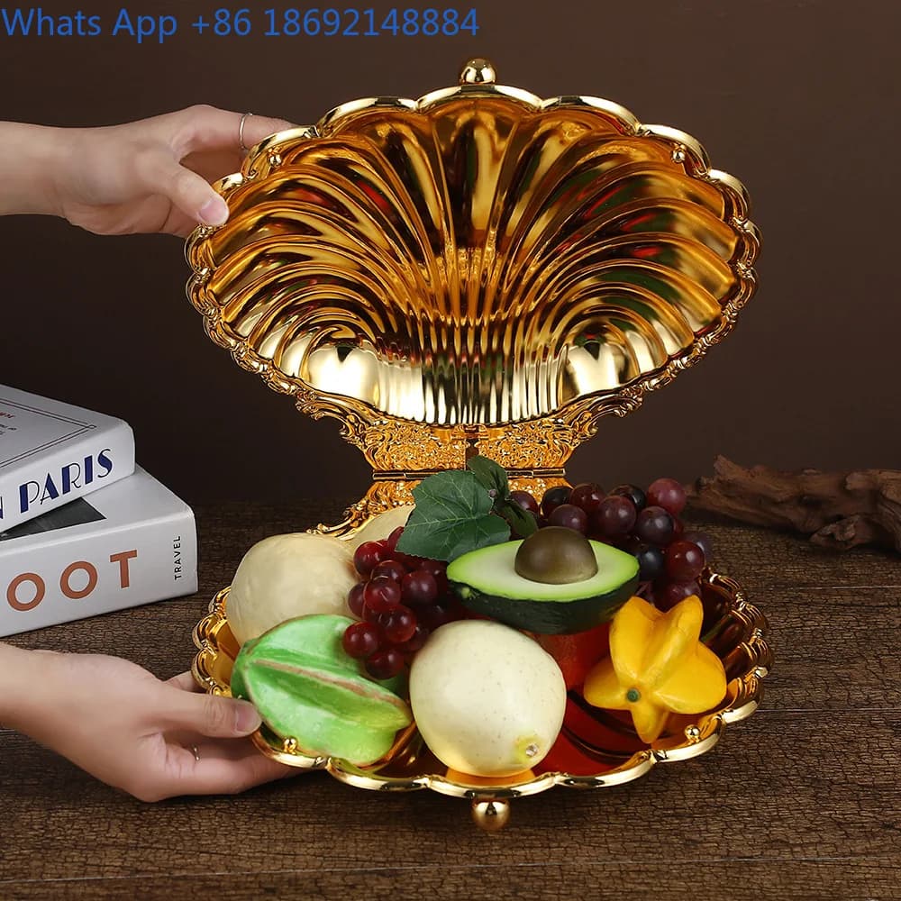 Piatto di frutta con guscio di vongole dorate dal design creativo, leggero di nicchia, tavolo da pranzo per la casa di lusso, squisito piatto per snack di frutta secca