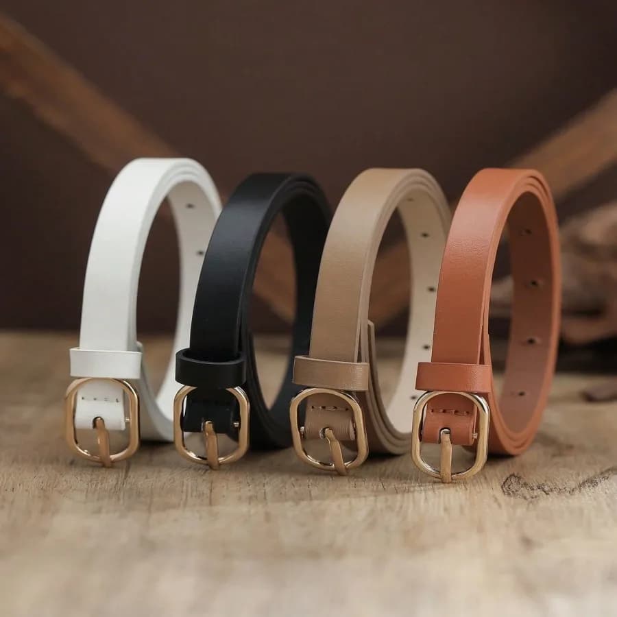 A set of 3 thin waist belts with a simple oval golden buckle, which are versatile.