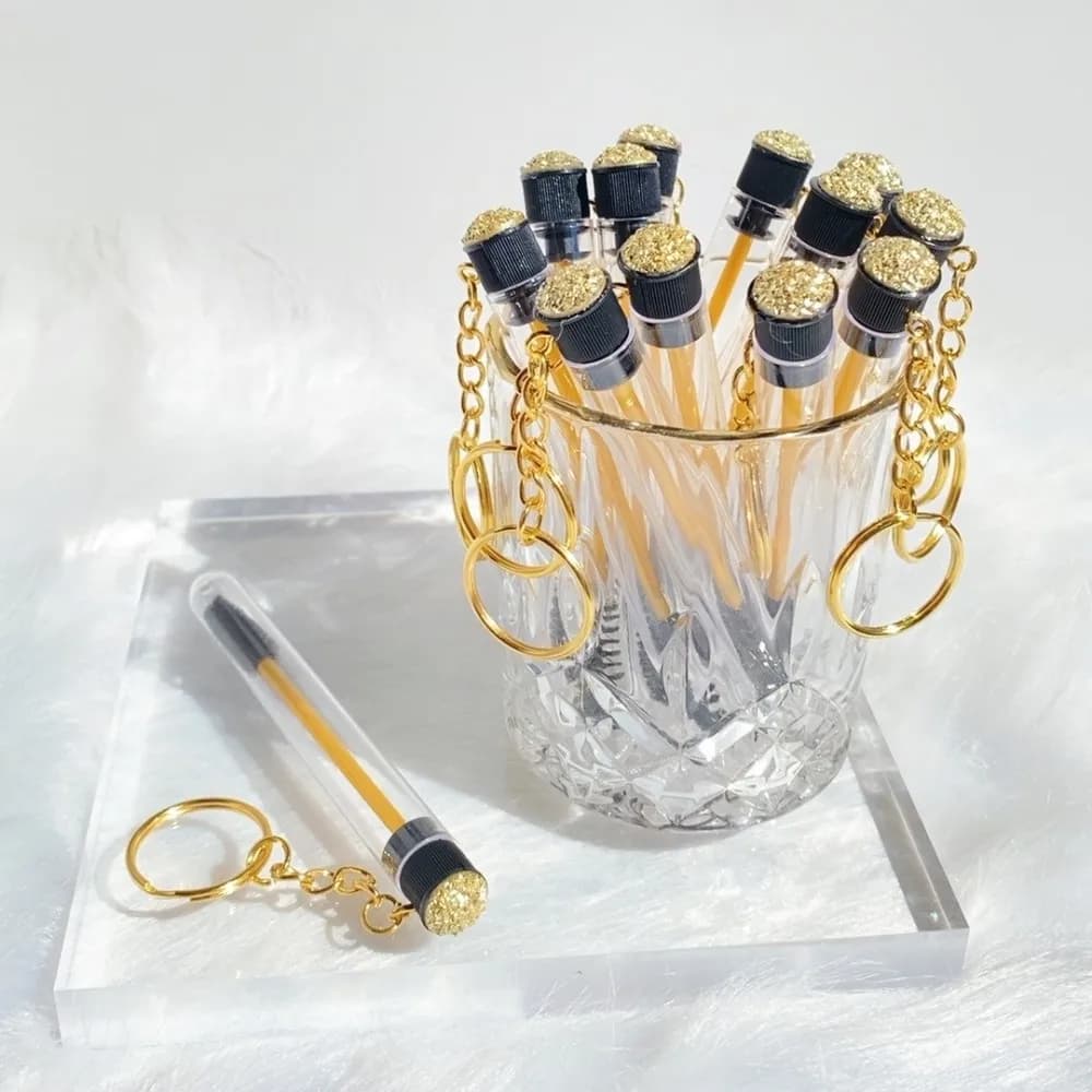 Keychain with gold reusable eyelash brush tube, plastic spool container, glitter, mascara, wands, key rings