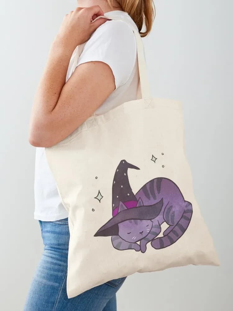 A cute sleeping galactic cat with a witch hat. Women's tote bag. Women's shopper bag. Beach bag.