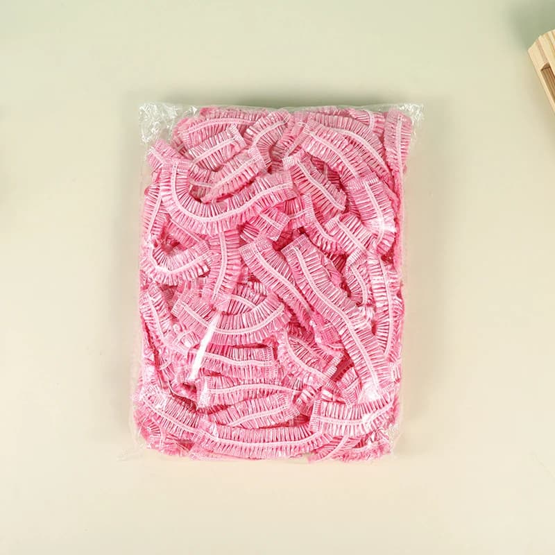100 Pezzi/set Cuffia da doccia usa e getta da donna Copricapo impermeabile in plastica Rosa Spa Salon Hotel Tintura per capelli Cuffia elastica per capelli