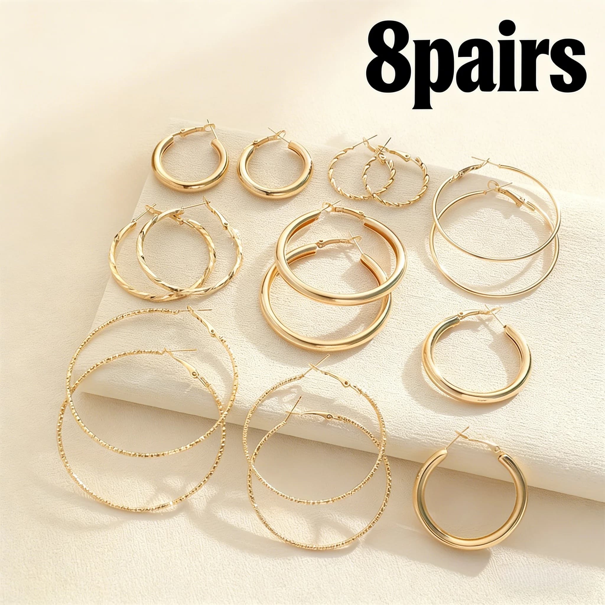 8 pairs of a set of eight pairs of earrings in gold from woman. presents hypoallergenic studs and pendants for a versatile daily style.