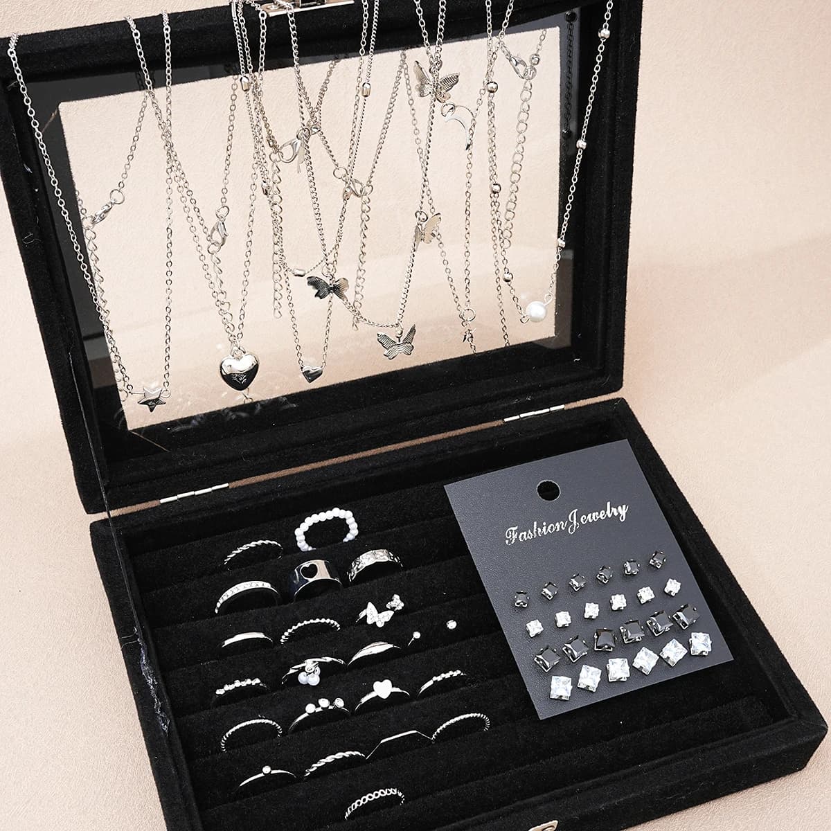 Set of 51 pieces silver chic jewelry for women, necklaces, earrings and rings with butterfly, heart and pearls, combined with everyday outfits.