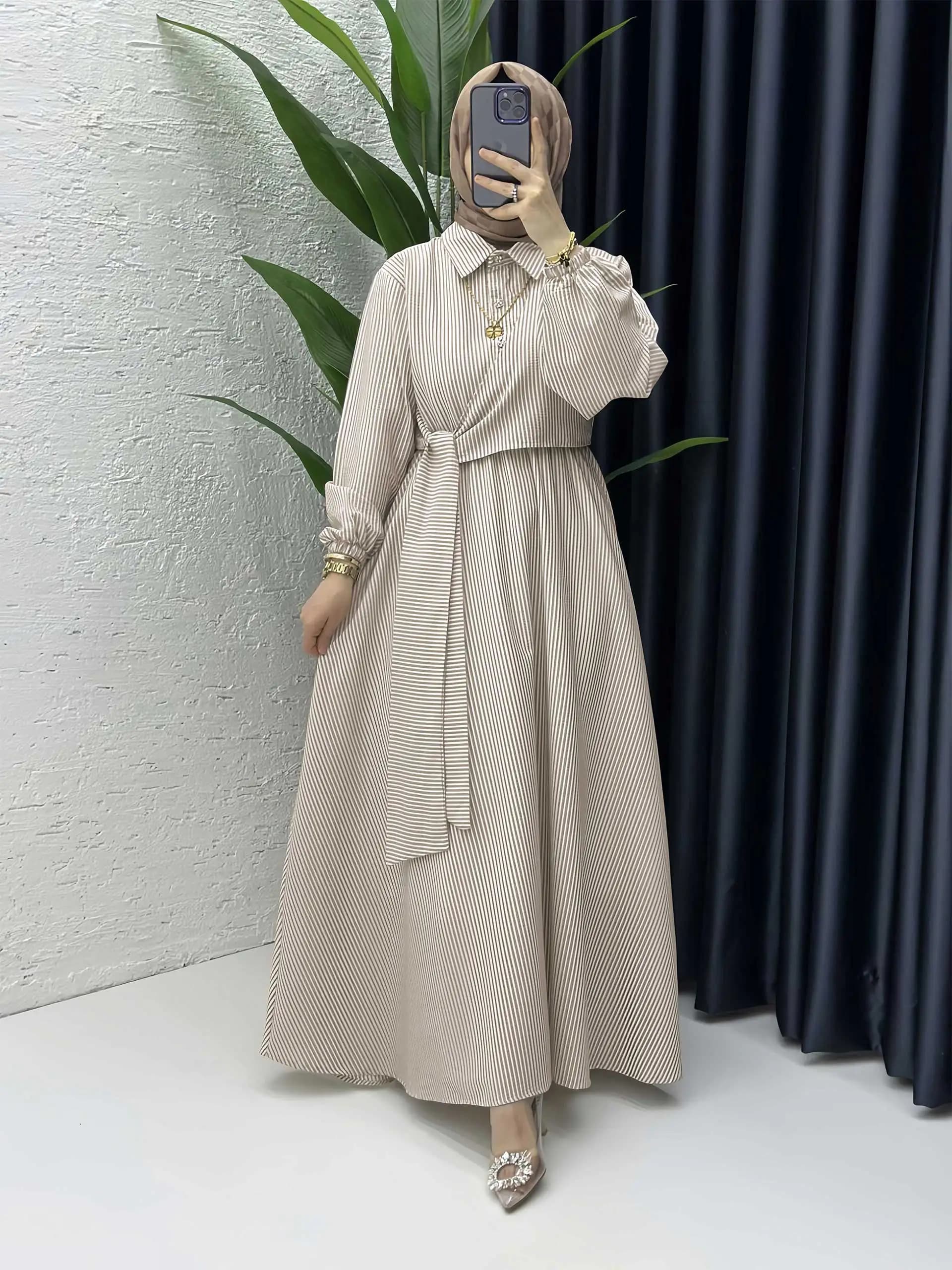Beige striped Abaya inspired by Dubai with shirt collar and waist belt, ideal for urban chic Arabic look and mosque